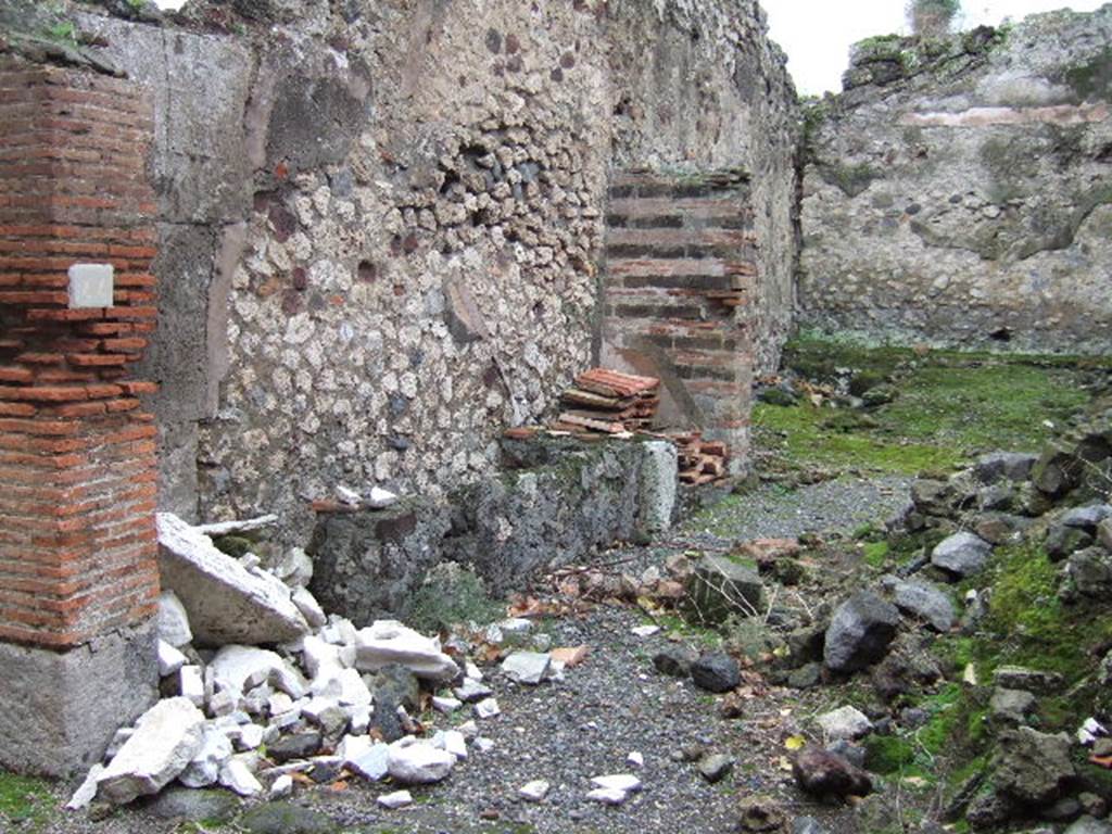 VII.9.44 Pompeii. December 2005. Looking south-east across entrance doorway.  According to Eschebach on the left would have been the remains of the base two steps of the stairs to the upper floor. See Eschebach, L., 1993. Geb�udeverzeichnis und Stadtplan der antiken Stadt Pompeji. K�ln: B�hlau. (p.316)
 