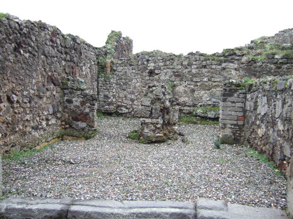 VII.9.50 Pompeii. December 2005. Looking south across shop, to two rear rooms. According to Fiorelli, the shop had a counter with a simple hearth and at the rear were two rooms, one with the usual staircase. See Pappalardo, U., 2001. La Descrizione di Pompei per Giuseppe Fiorelli (1875). Napoli: Massa Editore.(p107) According to Liselotte Eschebach, to the left was a rear room with a hearth, and a downpipe from latrine on upper floor. To the right was another room with a staircase to the upper floor. See Eschebach, L., 1993. Gebäudeverzeichnis und Stadtplan der antiken Stadt Pompeji. Köln: Böhlau. (p317)