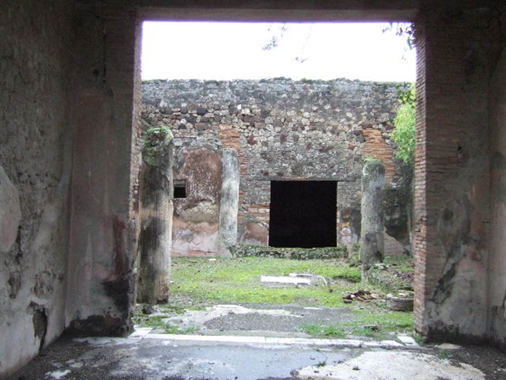 VII.10.3 Pompeii. December 2005. Looking east from tablinum into garden room 13. According to Jashemski, the garden at the rear of the tablinum, excavated in 1863, was enclosed by a portico on the west, south and east sides. The portico was supported by five white, fluted, stuccoed columns. There was an engaged column at the north-west corner. A low wall joined the columns, leaving an entrance to the garden opposite the wide entrance from the tablinum. At the south end of the garden was a small pool with a hole in the centre for a fountain jet. There was a gutter around the edges of the garden. On the north wall was a large animal painting, but nothing now remains of this painting except the wide red border. There was a good view of the garden from the exedra at the rear.
See Jashemski, W. F., 1993. The Gardens of Pompeii, Volume II: Appendices. New York: Caratzas. (p.191)