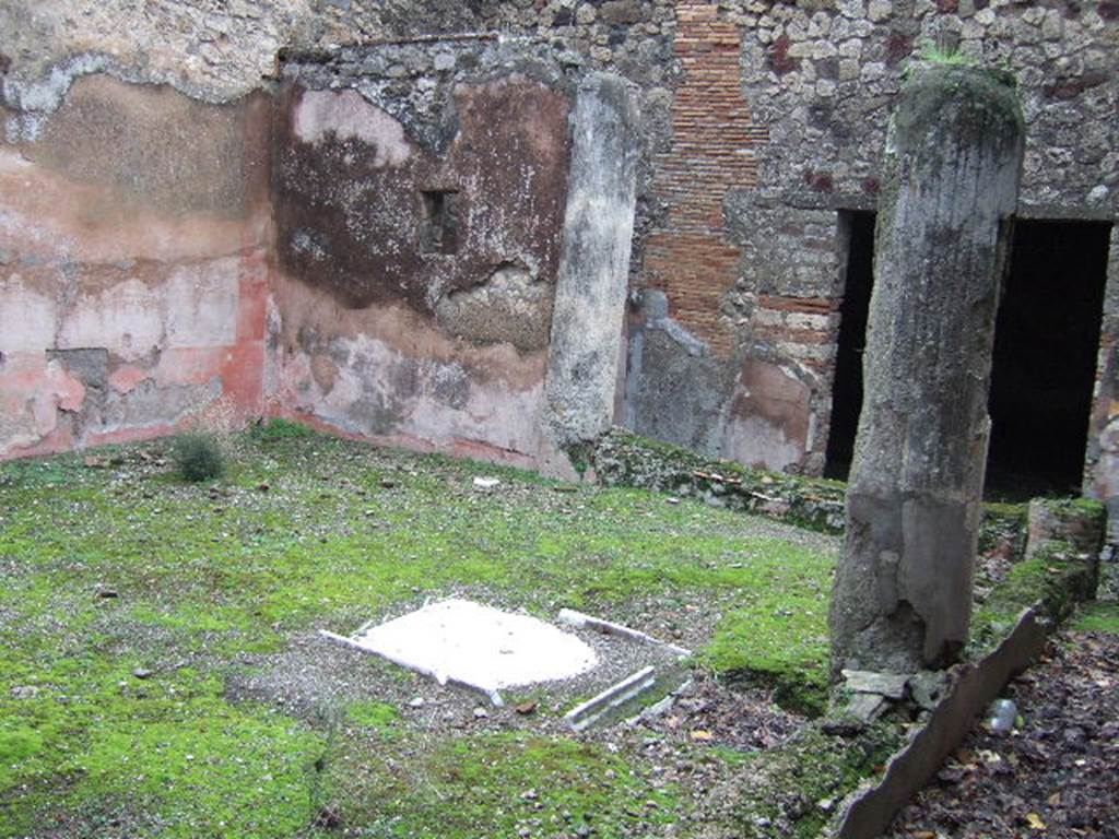VII.10.3 Pompeii. December 2005. Looking towards east wall, and columns of portico joined a low wall, of garden room 13. (At the rear, the square doorway to the exedra can be seen in the photo above.)
According to Amoroso, at the rear of the atrium is a small internal courtyard or peristyle, reached by passing through the tablinum. Three rooms were on the east side of the peristyle, two of them opened onto it. He describes “our room 14” as a large exedra, and on its north side were two cubiculi (“our rooms 15 and 16”) in which was preserved a rich IVth style wall decoration.
Studi della Soprintendenza archeologica di Pompei, 22: l”Insula VII, 10 di Pompei, by Angelo Amoroso, (p.55)
According to Breton, the low wall (pluteus) joining the columns was painted a very bright red. At the rear, east side, of the peristyle were two rooms. In the north wall of the exedra was a small back door that led into a very small room that seemed to have served as an anteroom for a well decorated room that had a second entrance onto the peristyle.
See Breton, Ernest. 1870. Pompeia, Guide de visite a Pompei, 3rd ed. Paris, Guerin.