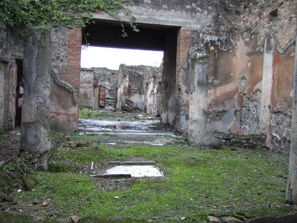 VII.10.3 Pompeii. December 2005. Looking west from the exedra room 14, across the peristyle, through the tablinum, towards the house entrance. The doorway leading to VII.10.14 is on the left.