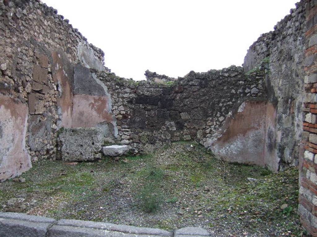 VII.10.4 Pompeii. December 2005. Looking east across shop. On the left at the rear can be seen a block of travertine which was the base step for the wooden steps that would have led to the upper floor. The line of the stairs could be traced in the plaster on the north wall.