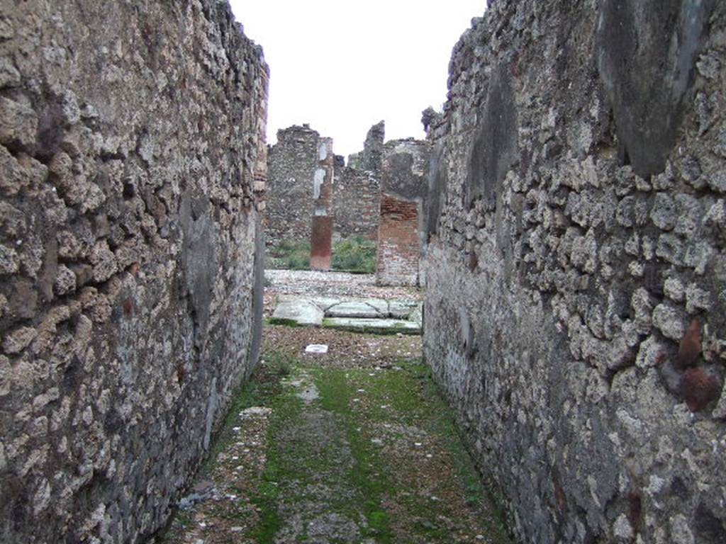 VII.10.5 Pompeii. December 2005. Entrance corridor, looking east to atrium. The long fauces stretched eastward, to the detriment of the atrium. The moving and renewing of the impluvium also required the creation of a new emptying system, which meant breaking and relaying the previous atrium and fauces flooring. This resulted in the patches, seen above, in the fauces flooring.
Studi della Soprintendenza archeologica di Pompei, 22: l'Insula VII, 10 di Pompei , by Angelo Amoroso. (p.80)