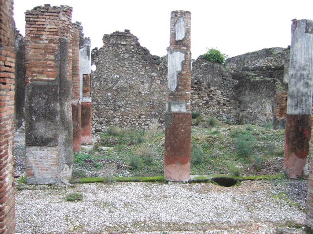 VII.10.5 Pompeii. December 2005. Looking east through doorway from atrium to peristyle. According to Jashemski, at the rear of the atrium was the peristyle garden, excavated in 1863. It was enclosed on the north, west and south by a portico supported by seven columns. The columns were red at the bottom, white and fluted above. There was a pillar flanked by two half-columns at the north-west corner. There was a gutter around the edges of the garden.
See Jashemski, W. F., 1993. The Gardens of Pompeii, Volume II: Appendices. New York: Caratzas. (p.191)