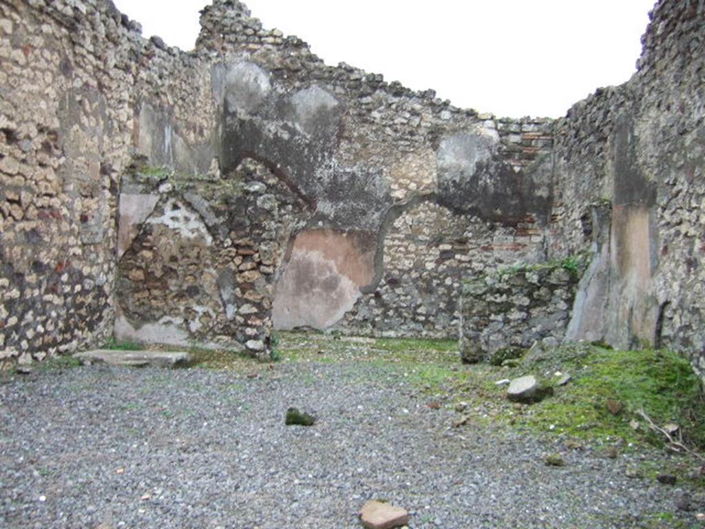 VII.10.6 Pompeii. December 2005. Looking east across shop towards doorway to rear room.
In the north-east corner of the shop-room (on left) can be seen the remains of the base of steps to upper floor.
According to Amoroso, the floor of the shop was simple cocciopesto, whereas the rear room’s floor was the same flooring made with scattered polychrome pieces, similar to the adjacent atrium (of VII.10.5), of which this room had once been part. The walls of the two rooms were plastered with plaster without colour.
Studi della Soprintendenza archeologica di Pompei, 22: l”Insula VII, 10 di Pompei , by Angelo Amoroso. (p.69)
