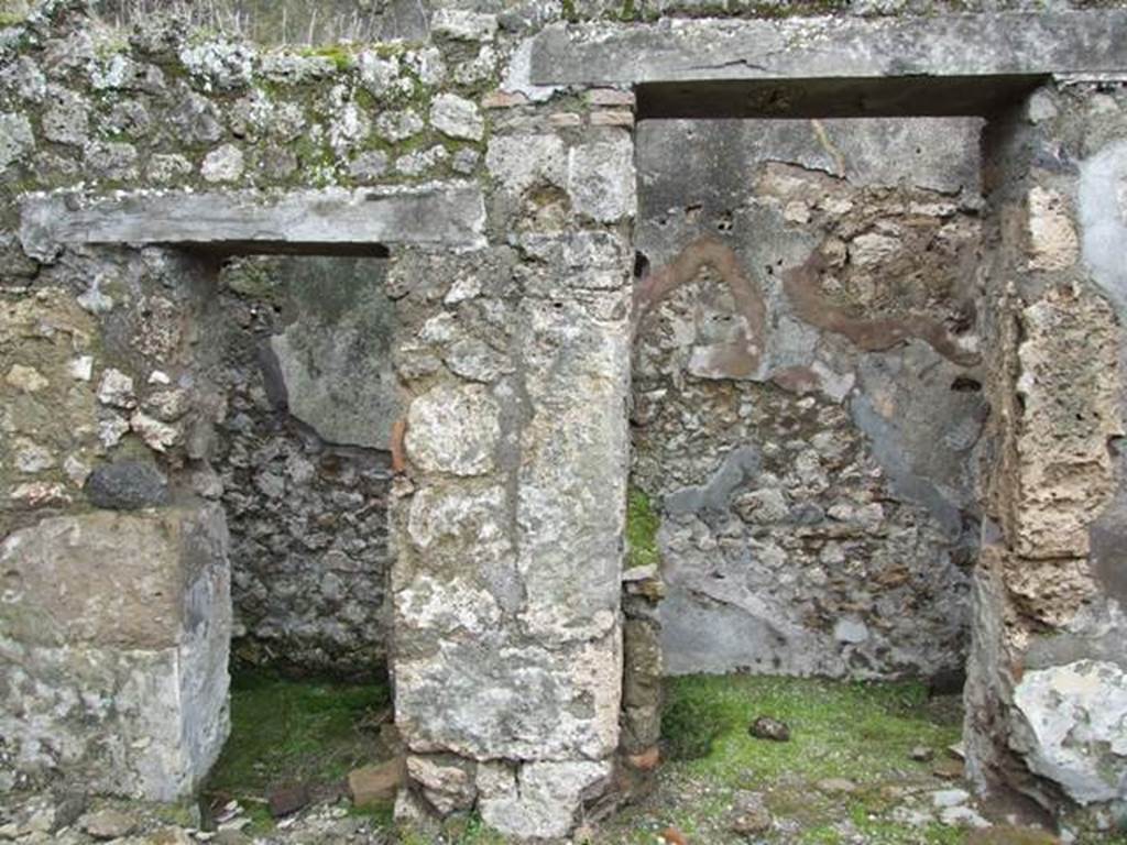 VII.10.9 Pompeii. March 2009. The doorway on the left is to the Latrine, and the one on the right is to the Kitchen. Looking west from atrium of VII.10.12