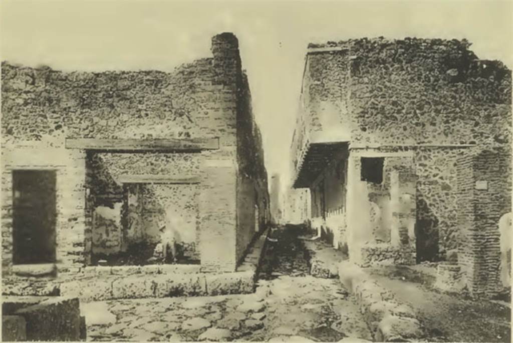 VII.10.11 Pompeii, on left. Old undated photo showing full height entrance doorway to steps to upper floor.
Looking west across junction of Vicolo della Maschera, lower left, with Vicolo del Balcone Pensile, in centre on right.