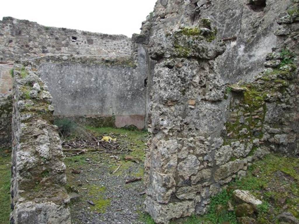 VII.10.12 Pompeii. March 2009. Doorway to triclinium in south-east corner of atrium.
According to Boyce, on the east wall of the atrium entered at number 12 was a lararium painting on a white background.
The Genius, wreathed and wearing a toga with a fold drawn over his head, held a cornucopia in his left hand.
With his right hand, he poured a libation from a patera onto a blazing altar around which a serpent was coiled.
His head was excellently preserved and exhibited the features of the Roman portrait type of the early Empire.
In the wall above the painting was a niche.
See Helbig, W., 1868. Wandgemälde der vom Vesuv verschütteten Städte Campaniens. Leipzig: Breitkopf und Härtel, (31).
See Fiorelli, G., 1875. Descrizione di Pompei. Napoli, p. 276.
See Boyce G. K., 1937. Corpus of the Lararia of Pompeii. Rome: MAAR 14. (p.69, no.309, numbered as VII.x.9-12).