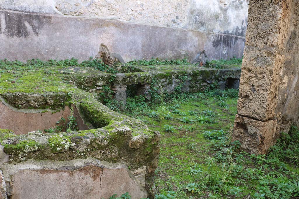 VII.10.13, Pompeii. December 2018.
Looking west from entrance doorway towards basin and two hearths, near south wall. Photo courtesy of Aude Durand.