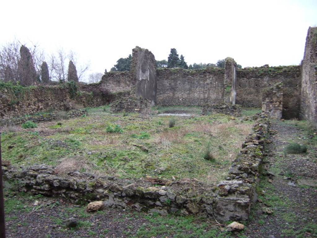 VII.11.6 Pompeii. December 2005. Garden area looking south towards exedra in centre of south wall. December 2005. According to Helbig, found in the middle room behind the peristyle was a painting of Oreste and Pilades at Tauris.
See Helbig, W., 1868. Wandgemälde der vom Vesuv verschütteten Städte Campaniens. Leipzig: Breitkopf und Härtel. (1335)
According to Jashemski, this once fine house, converted into a hospitium after the earthquake, at one time had a large peristyle garden.
It had a portico on all four sides. The columns were joined by a low wall which enclosed the garden, leaving one entrance to the garden on the north, and two on the south. A cistern opening was enclosed in the low wall on the north. Only a few stumps of the columns are preserved.
There was a gutter around the edges of the garden.
See Jashemski, W. F., 1993. The Gardens of Pompeii, Volume II: Appendices. New York: Caratzas. (p.192)