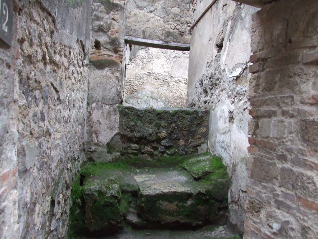 VII.11.12 Pompeii. December 2006. Cella meretricia with stone bed, under steps to upper floor.
Traces of steps are visible on the wall on the right-hand side of picture.