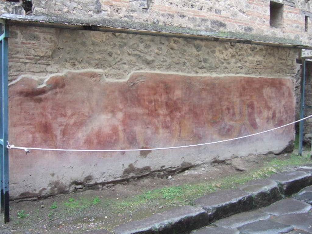 VII.11.13 Pompeii. December 2005. Painted street shrine.
According to Fiorelli, “a painting adorned the exterior of this edifice facing the House of Siricus. In the painting were two serpents, one male and one female, approaching an altar from either side. On the altar were two pine cones and two eggs. Above was written in white letters –
OTIOSIS . LOCVS HIC . NON EST DISCEDE
MORATOR
and then to the right towards the extremity of the painting, written in white, a record of the wine drunk in the inn, with above
L(V)MPAS
ROMANESES
which I believe is a reference to the Genius of the nearby baths”.
See Pappalardo, U., 2001. La Descrizione di Pompei per Giuseppe Fiorelli (1875). Napoli: Massa Editore. (p.110)