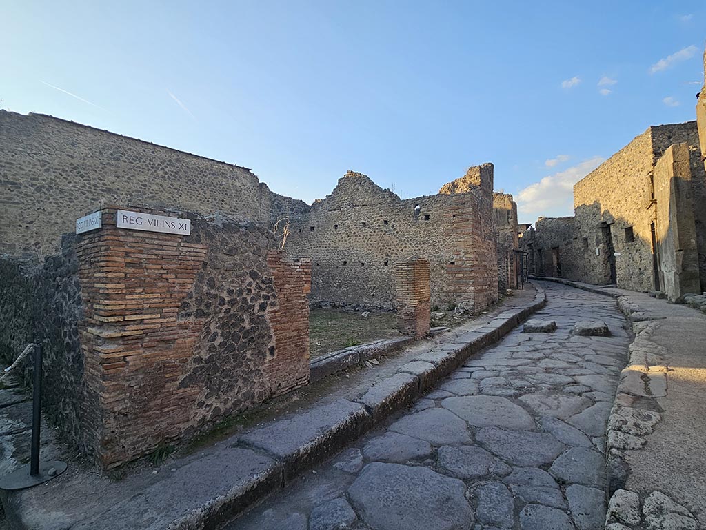 VII.11.17 and 16 Pompeii. November 2024.
Looking towards entrance doorways on west side of Vicolo del Lupanare. Photo courtesy of Annette Haug.