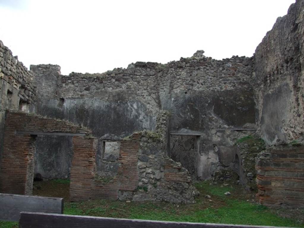 VII.12.14 Pompeii. December 2007. Looking south to rear room, and area with staircase.
According to Fiorelli, this house was more noble than the preceeding ones and the last shop in the vicolo. Its triclinium, adorned with a little painting depicting bearded Pan in the act of raising the mantle of a sleeping Bacchante, was lit by a window which overlooked the roadway, and looked into another nearby triclinium. It had a passageway with stairs to the upper floor, and an area at the rear which was discovered with a large latrine in its corner.
See Pappalardo, U., 2001. La Descrizione di Pompei per Giuseppe Fiorelli (1875). Napoli: Massa Editore. (p.111) According to BdI, found in a room here was a copy of a painting, often repeated, showing bearded Pan lifting the dress of a sleeping Bacchante.
The dress was a reddish colour. The painting, which had suffered much, had the height and width of 0.37m. See BdI, 1864, (p.116, described as Casa VI.)