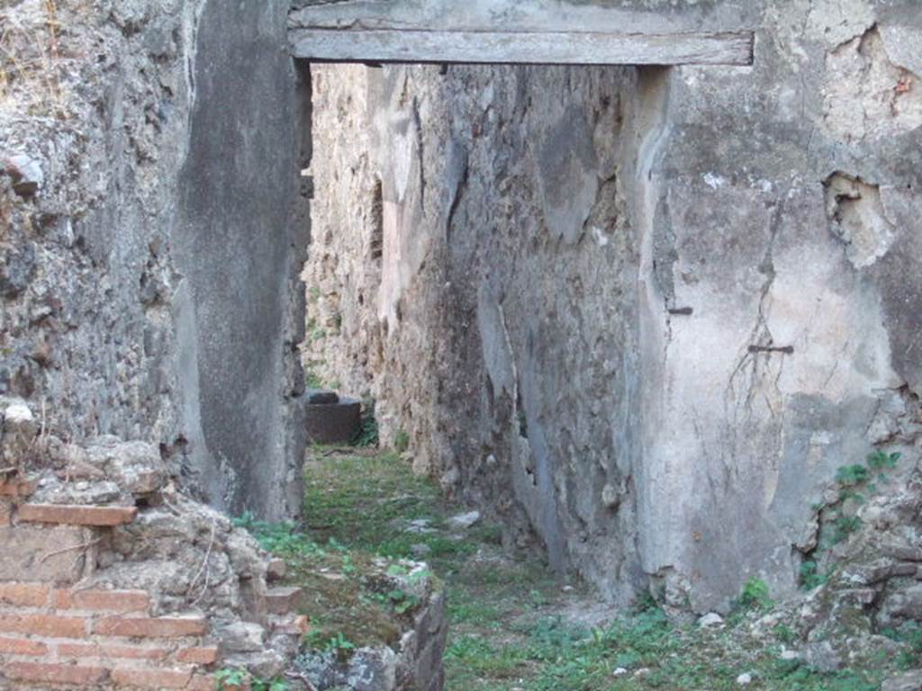 VII.12.14 Pompeii. September 2005. Corridor to rear. According to Jashemski, there was probably a garden in the open area at the rear of this shop-house which Della Corte had identified as a location of a school.
She gave references – Fiorelli, Scavi, pp. 19: Idem: Descr. p. 284.
Della Corte, « Scuole e maestri in Pompei antica » Studi Romani, 7 (1959).
See Della Corte, M., 1965. Case ed Abitanti di Pompei. Napoli: Fausto Fiorentino. (p.183-4).
See Jashemski, W. F., 1993. The Gardens of Pompeii, Volume II: Appendices. New York: Caratzas. (p.193)