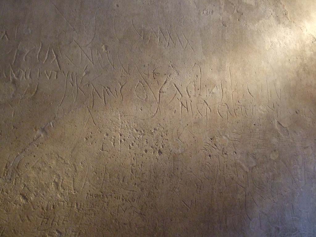 VII.12.18 Pompeii. December 2006. Plastered wall of prostitute’s room.
Covered with graffiti left by the clients and the girls that worked there.