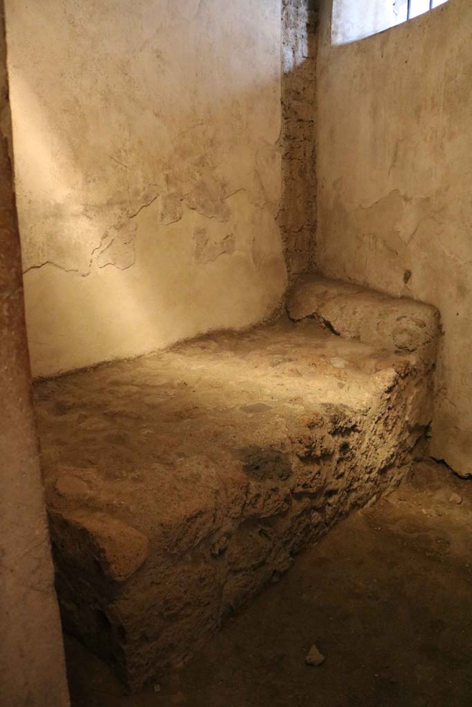 VII.12.18 Pompeii. December 2018.
Looking towards stone bed and pillow in room for prostitute. Photo courtesy of Aude Durand.