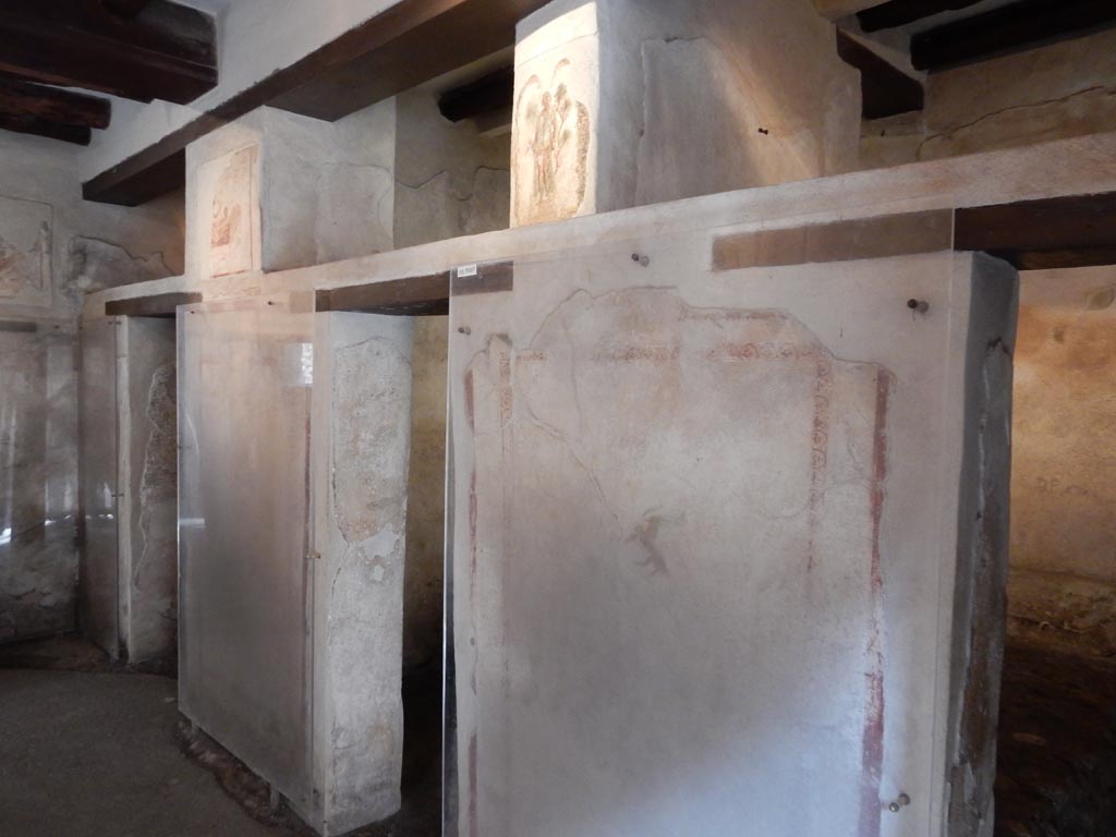 VII.12.18 Pompeii. May 2015.
Looking towards three doorways on north side, with frieze on the upper wall. Photo courtesy of Buzz Ferebee.