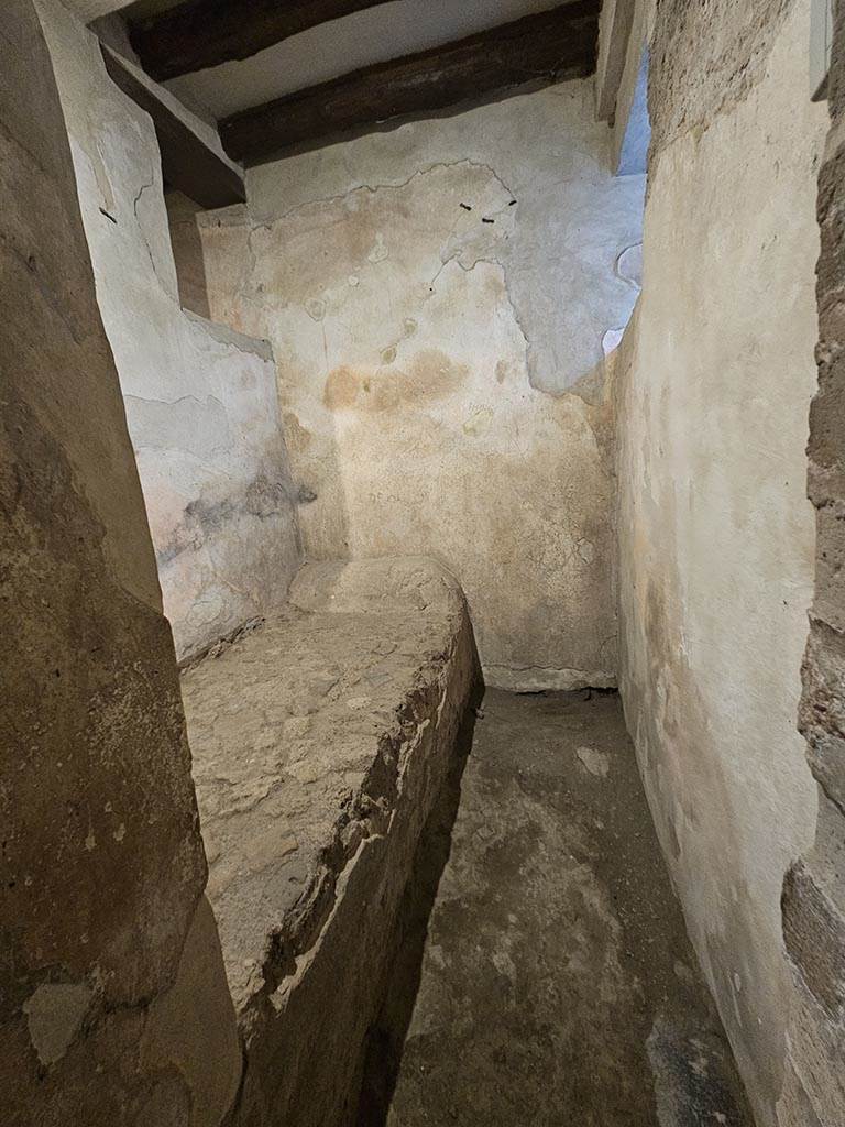 VII.12.18 Pompeii. November 2024.
Looking north into room for prostitute with stone bed. Photo courtesy of Annette Haug.