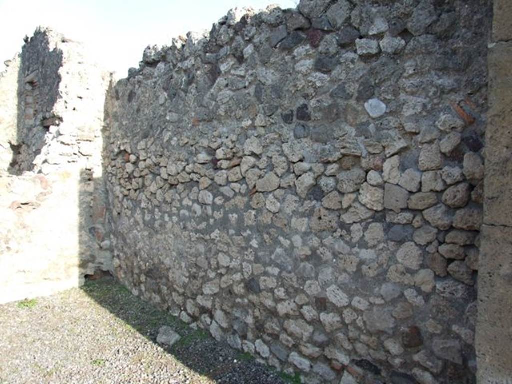 VII.13.6 Pompeii. December 2007. East wall, with remains of clay pipe in north-east corner from latrine on upper floor.