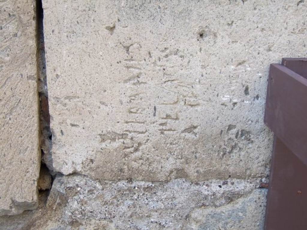 VII.13.14 Stone block with inscription at corner of Vico della Maschera and Vico degli Scheletri.