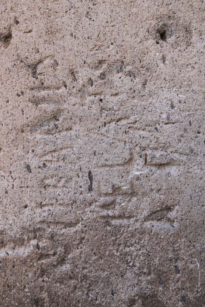 VII.13.14 Pompeii. December 2018.
Stone block with inscription at corner of Vicolo della Maschera and Vicolo degli Scheletri.
Photo courtesy of Aude Durand.