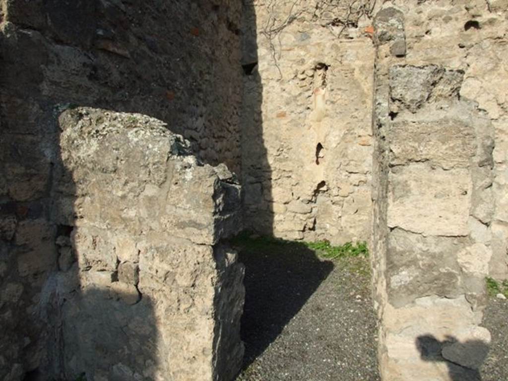 VII.14.2 Pompeii. December 2007. Looking north through doorway to rear room with site of steps to upper floor, and a latrine. According to Boyce, a fragmentary painting on the wall of the kitchen appeared to have belonged to a lararium originally painted above it. Three men (the heads are missing) are busied about a hog. Below lay the carcass of a slaughtered animal, opened as if for divination from the entrails. He gave the reference – Helbig 83.
See Boyce G. K., 1937. Corpus of the Lararia of Pompeii. Rome: MAAR 14. (p.71, no.325)