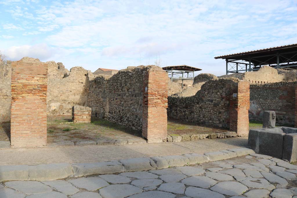 VII.14.12, Pompeii, on left. December 2018.
Looking north-east to entrance doorways, with VII.14.13, on right. Photo courtesy of Aude Durand