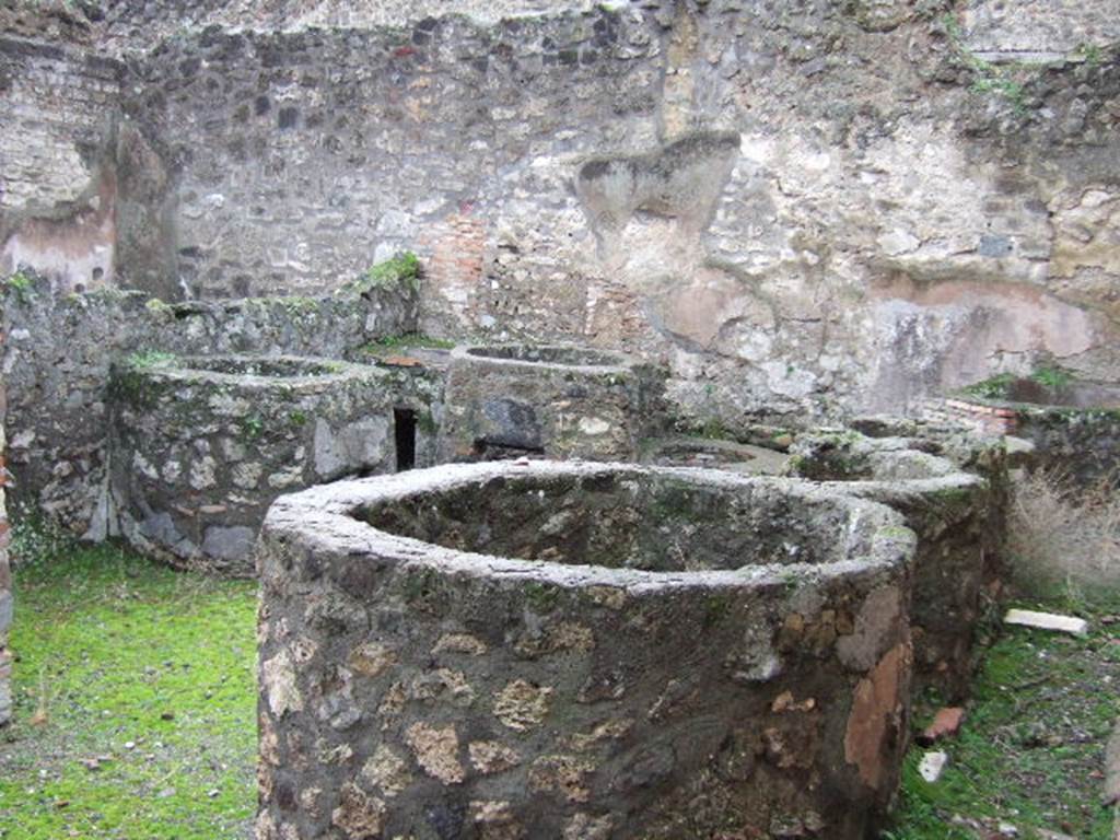 VII.14.17 Pompeii. December 2005. Looking west from entrance across vats with built in hearth.