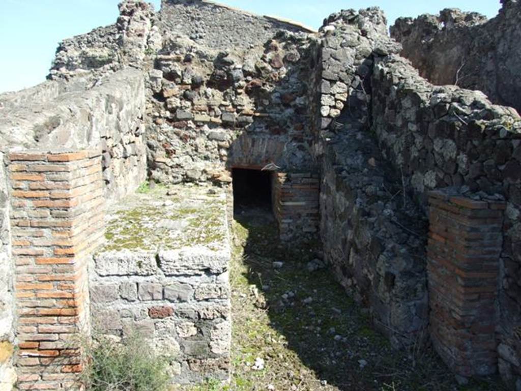 VII.15.2 Pompeii. March 2009. Kitchen. Hearth, oven and remains of stairs on right to upper floor.