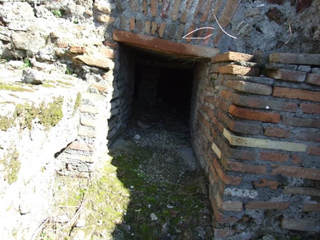 VII.15.2 Pompeii. March 2009. Kitchen. East wall. Entrance to praefurnium for the caldarium which was stoked from the kitchen.