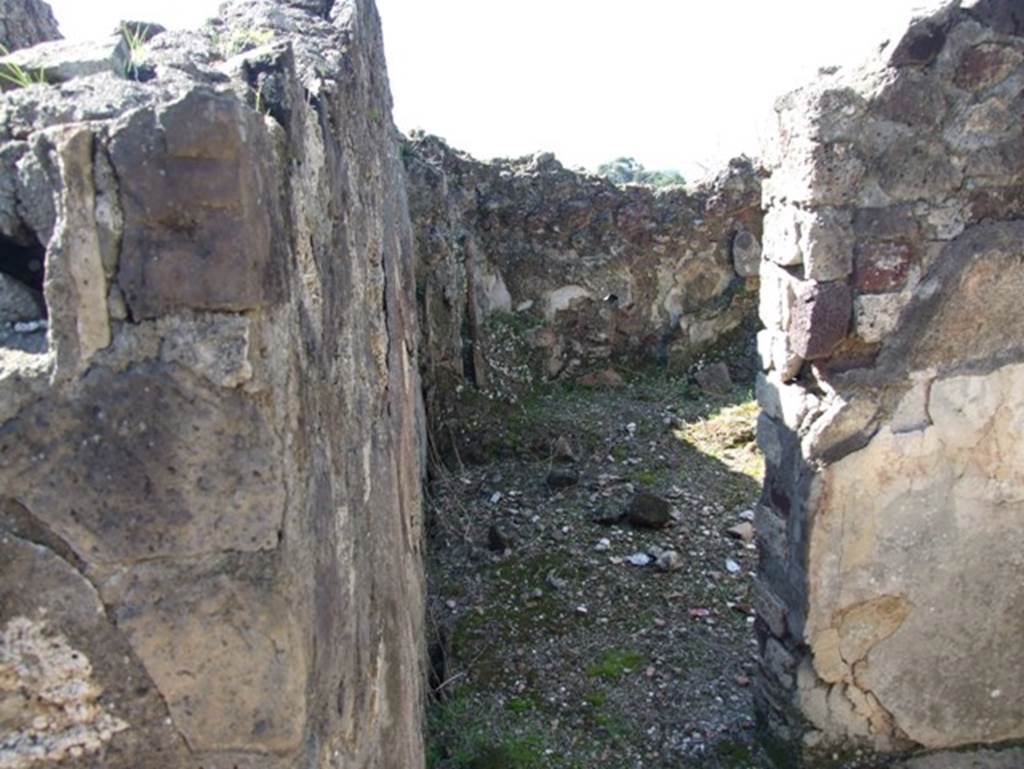 VII.15.2 Pompeii. March 2009. Tepidarium with doorway into caldarium.
The caldarium had a hypocaust system, complete with suspensurae beneath its floor. Regulae mammatae lined its south, west, and north walls. The praefurnium was stoked from the kitchen, which was on the west side. The wall decoration of the caldarium was Second style, but no further details were recorded. The floor was paved with cocciopesto.
See Franklin, J.L., 1990. Pompeii, the Casa del Marinaio and its history. Rome: L’Erma di Bretschneider