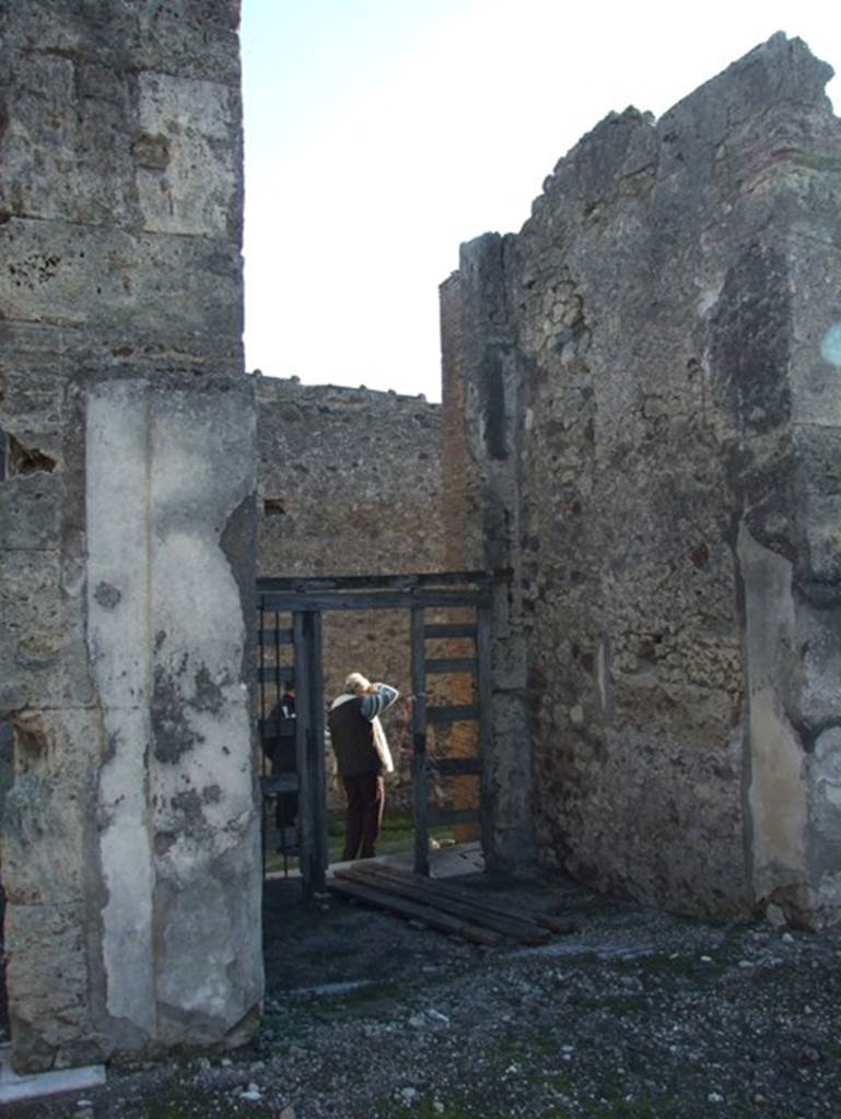VII.15.2 Pompeii. December 2007. Fauces, or entrance corridor, looking south from atrium. This entrance corridor had a mosaic depicting a colonnaded sea front revealing the prows of ships through the six arches.
A dolphin and an anchor were also in the surround. This is how the house got its name.