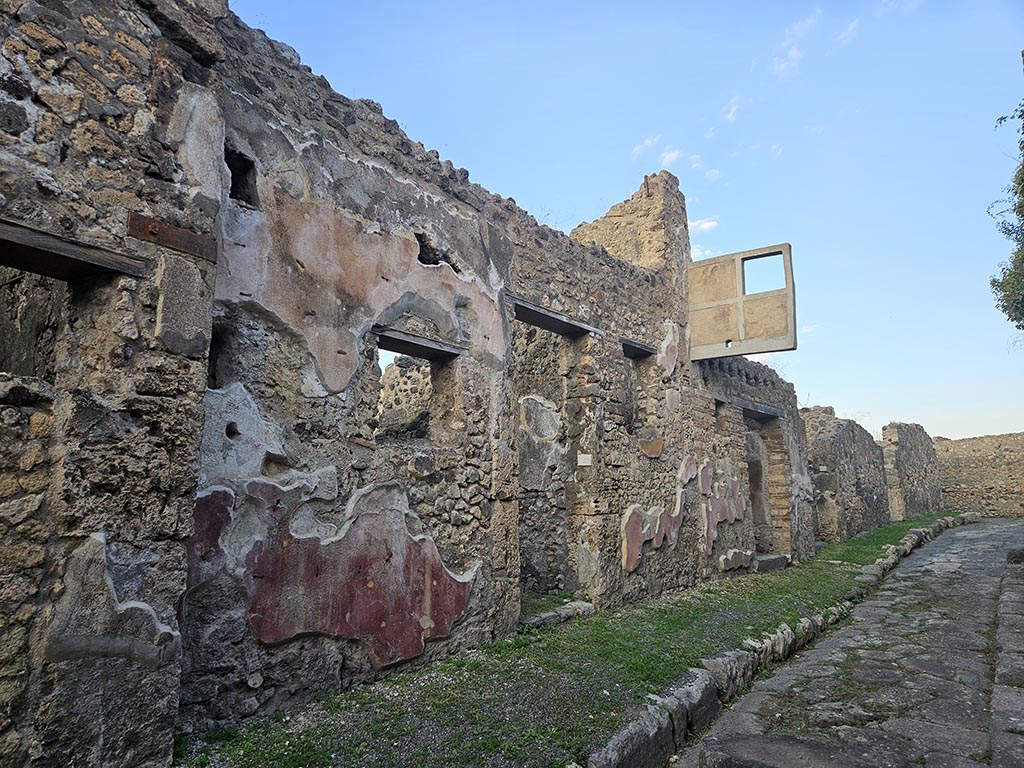 VII.15.4 and VII.15.5, Pompeii. November 2024.
Looking east towards entrance doorways with VII.15.4 in centre, and VII.15.5, centre right. Photo courtesy of Annette Haug.