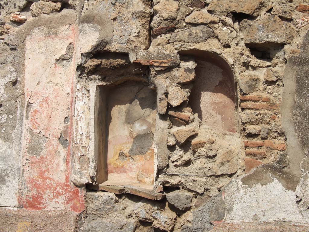VII.15.5 Pompeii. September 2005. Niches. Boyce recorded a rectangular niche with a red panel on each side.
Each panel was painted with a yellow and black serpent coiling upwards with the head at the top.
See Boyce G. K., 1937. Corpus of the Lararia of Pompeii. Rome: MAAR 14. (p. 72, no.330, plate 12,3).