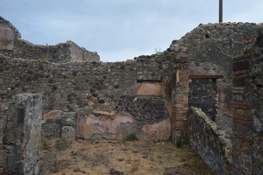 VII.15.12 Pompeii. March 2018. Looking east across room described as “central atrium-like room” or triclinium.
Foto Taylor Lauritsen, ERC Grant 681269 DÉCOR.
According to Boyce, in the east wall of the central atrium-like room was a shallow, rectangular niche of unusual proportions.
Its walls were coated with yellow stucco and decorated with red stripes; the Bull. Inst. referred to it as “forse un larario”.
See Bullettino dell’Instituto di Corrispondenza Archeologica (DAIR), 1874, 71.
See Boyce G. K., 1937. Corpus of the Lararia of Pompeii. Rome: MAAR 14. (p.72, no.333).