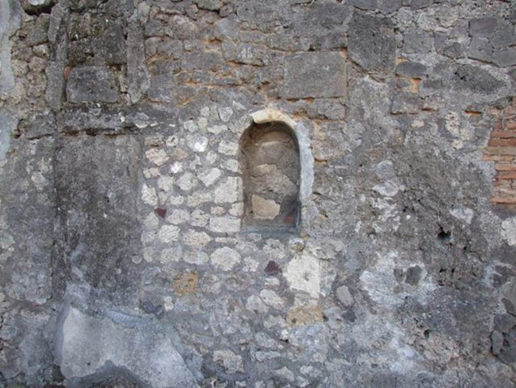 VII.15.13 Pompeii. December 2007. Arched Niche in Atrium. According to Boyce, the walls inside the niche were painted with birds perching upon leafy boughs. They were painted in red and blue on the white background.
See Boyce G. K., 1937. Corpus of the Lararia of Pompeii. Rome: MAAR 14. (p.72, No. 334).