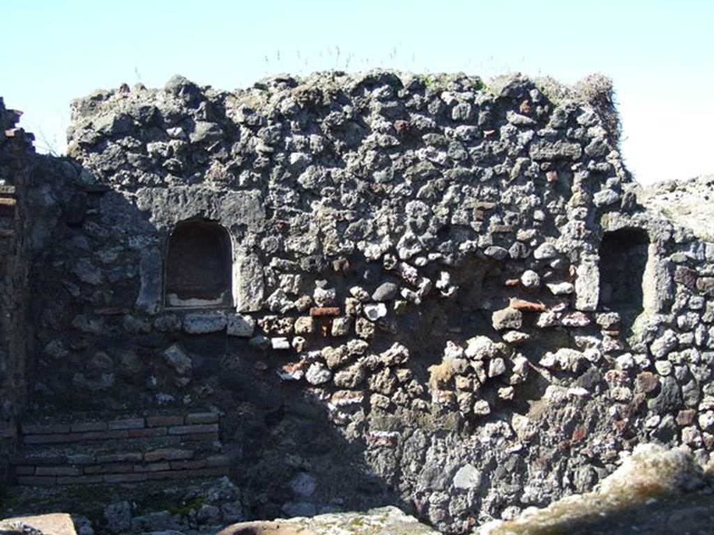 VII.16.7 Pompeii. March 2009. West wall with two arched niches. According to Boyce, these two arched niches, of similar size, were described by Fiorelli as “due nicchie per I Penati”. See Boyce G. K., 1937. Corpus of the Lararia of Pompeii. Rome: MAAR 14. (p.73, no.337)
