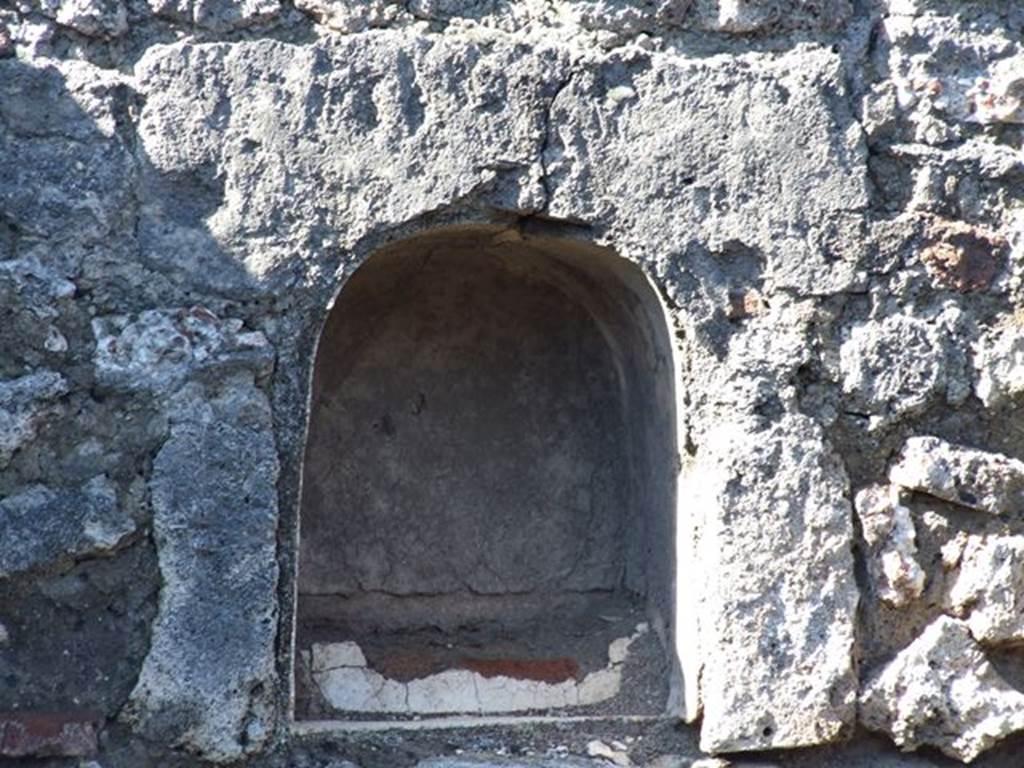 VII.16.7 Pompeii. March 2009. West wall, southern end. Arched niche with a low step, as described by Boyce. See Boyce G. K., 1937. Corpus of the Lararia of Pompeii. Rome: MAAR 14. (p73, No.337)