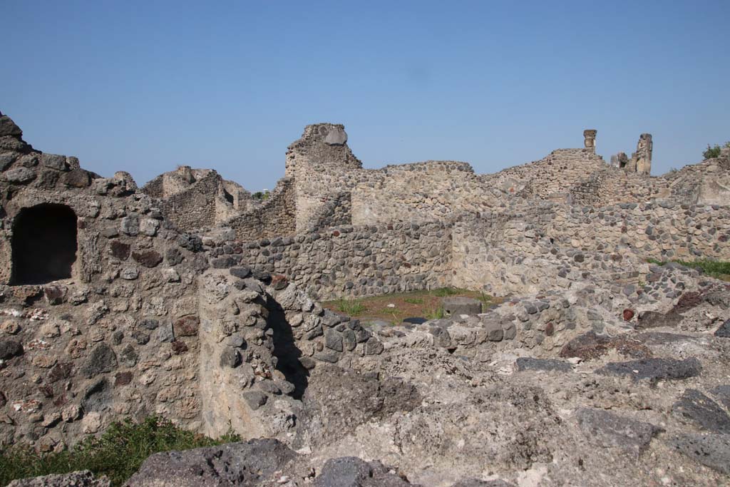 VII.16.7 Pompeii. September 2021.
Looking north-west at end of west wall, towards north end of workshop at VII.16.6. Photo courtesy of Klaus Heese.