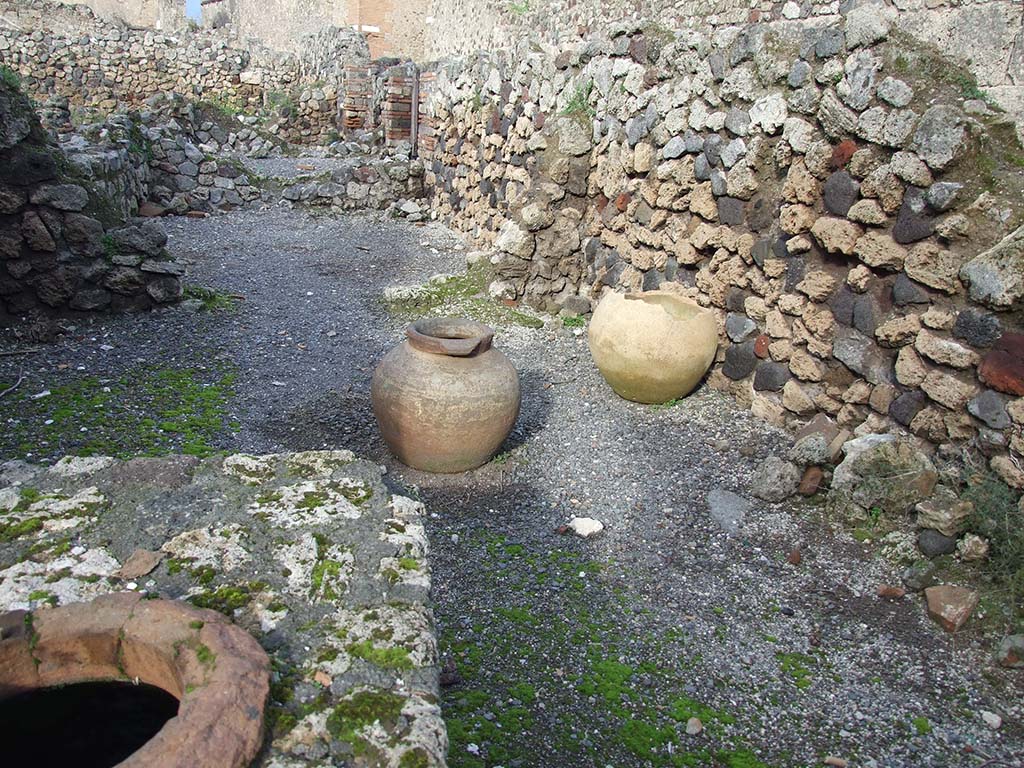 VII.16.7 Pompeii. December 2006. Looking north towards rear room and two dolia.
According to Garcia y Garcia, the thermopolium linked with VII.16.8 was destroyed by the 1943 bombing, then badly restored.
It deleted the doorway that was between the two properties.
See Garcia y Garcia, L., 2006. Danni di guerra a Pompei. Rome: L’Erma di Bretschneider. (p.131).