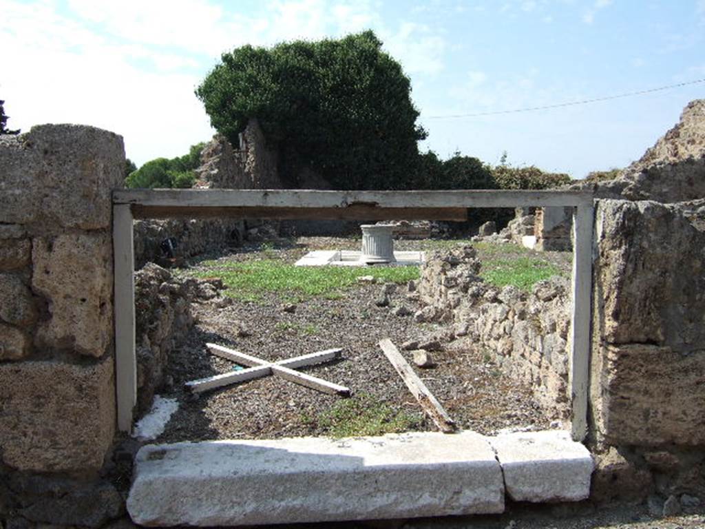 VII.16.10 Pompeii. September 2005. Looking west towards atrium from entrance doorway with marble sill. According to Fiorelli, in the Tuscanic atrium was a travertine impluvium, and on the left of the entrance was a doorway to a room. To the right of the entrance, was a doorway into the shop at VII.16.11, which seemed to have originally been the triclinium. On the same side, north of the atrium, was a cubiculum, an ala, and a rustic room that may have been the kitchen. In this last room was found a staircase to access the upper floor. Facing the entrance was the tablinum. This had two paintings now faded and lost, one was the likeness of Europa on the Bull, the other a feminine figure, that held out a papyrus to a sitting man. In front of the tablinum there was a base of material that may have held the arca or money chest. Adjoining was an oecus that also had a doorway from the atrium, and this was decorated with three paintings of major proportions, of which only two were visible. One represented Perseus and Andromeda, the other Drunken Hercules with Omphale. Omphale was accompanied by two maidservants and they looked down on him from on high. Also in the painting were cupids that harassed Hercules and raised up his weapons.
See Pappalardo, U., 2001. La Descrizione di Pompei per Giuseppe Fiorelli (1875). Napoli: Massa Editore. (p.161)
See Helbig, W., 1868. Wandgemälde der vom Vesuv verschütteten Städte Campaniens. Leipzig: Breitkopf und Härtel. (123, 1137, 1189, 1393b)
See Ragghianti, C.L., 1963. Pittori di Pompei. Milano: Edizioni del Milione, (p.47, fig 120, 121)
See Aoyagi, M, and Pappalardo, U. & others, 2006. Pompei, Reg.VI-VII, Insula Occidentalis. Valtrend Editore (p.543), article by Ivan Varriale.