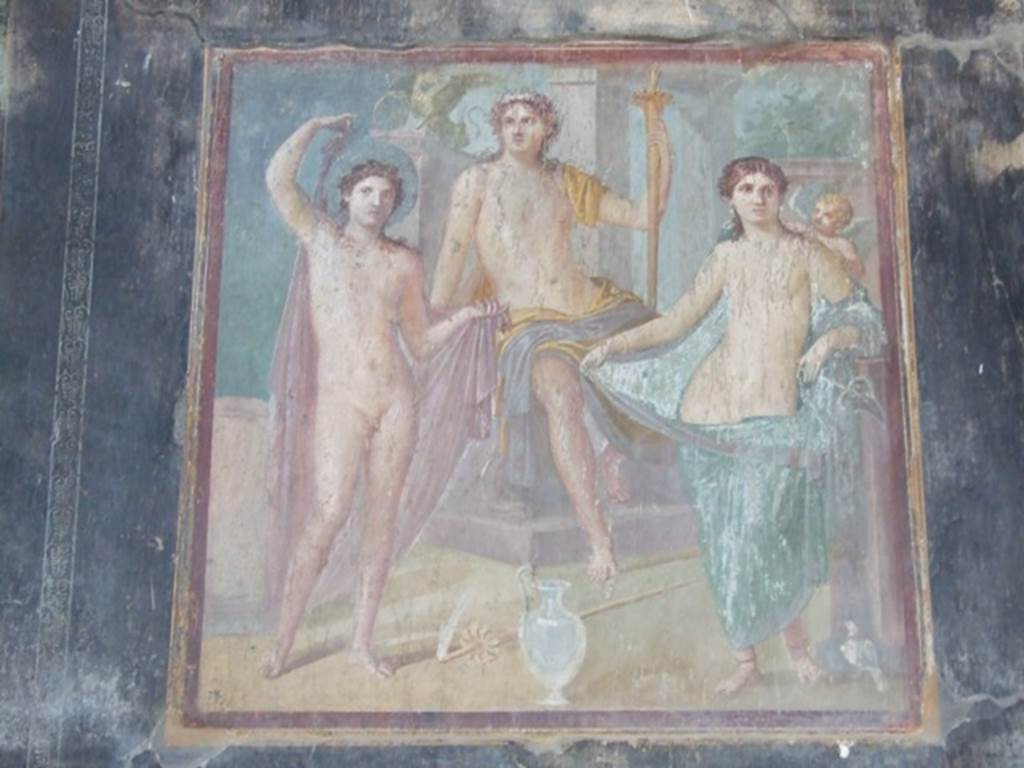 VII.16.17-22 Pompeii. December 2007. Wall painting from centre of east wall of oecus. Apollo sits on his throne, with a torch in his hand and a griffin on his throne. To his left is Venus with a cupid or Eros on her shoulder and a dove at her feet. To his right is Hesperus with a halo.
See Balch, D. L., 2008. Roman Domestic Art and Early House Churches. Tübingen, Germany: Mohr Siebeck. (p.160-2, Pl. 7). According to Grimaldi, this painting is of Apollo with Phaeton, Venus and cupid.
See Aoyagi M. and Pappalardo U. et al, 2006. Pompei (Regiones VI-VII) Insula Occidentalis. Napoli: Valtrend, (p.378)