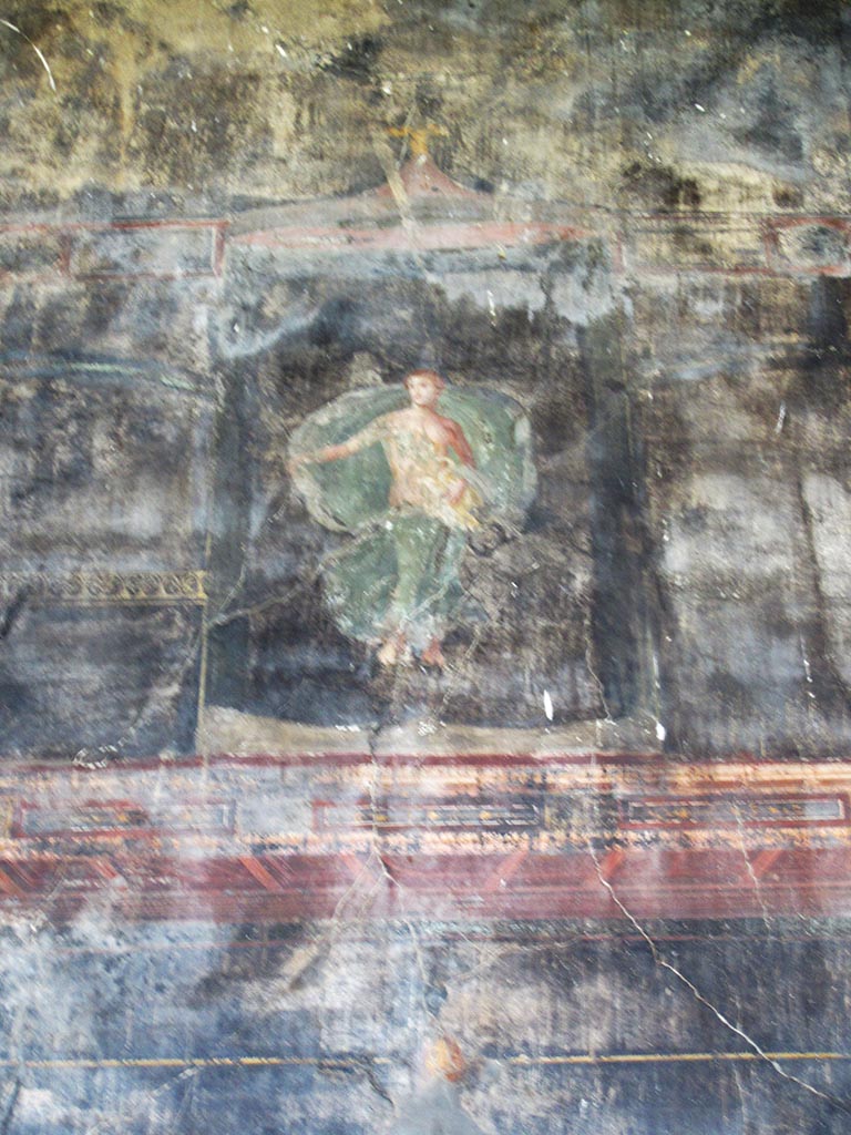 VII.16.17-22 Pompeii. May 2012.
Oecus 62, painted wall figure of Leda with the swan (Zeus) on her lap, from upper centre of east wall of oecus.
Photo courtesy of Marina Fuxa.