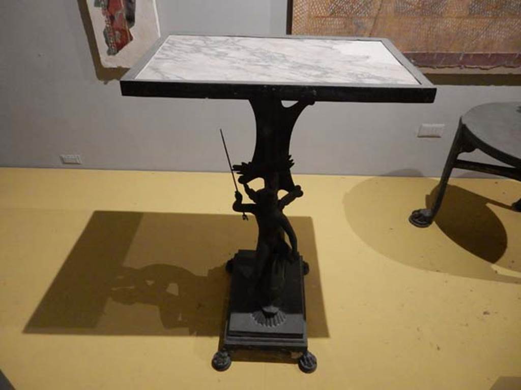 VII.16.17-22, Pompeii. May 2018.
Table in bronze and marble decorated with a cupid riding a dolphin, Archaeological Park of Pompeii, inv. 13371.
Photo courtesy of Buzz Ferebee.