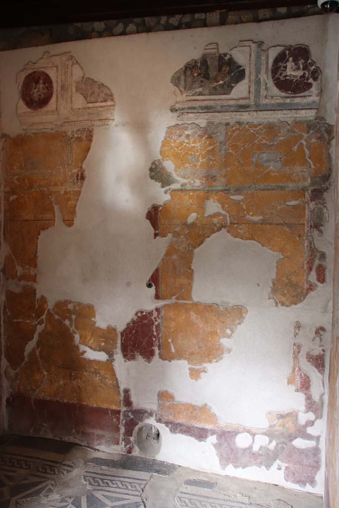 VII.16.a Pompeii. October 2020.
Room 1, north wall with pipe protruding from lower wall in centre. Photo courtesy of Klaus Heese.