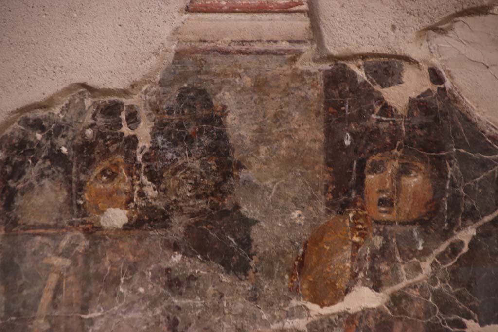 VII.16.a Pompeii. September 2021. Room 1, detail from painting of two masks on north wall. Photo courtesy of Klaus Heese.