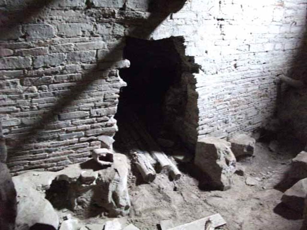 VII.16.a Pompeii. May 2010. Room 11, lower west wall, with hole into the furnace.