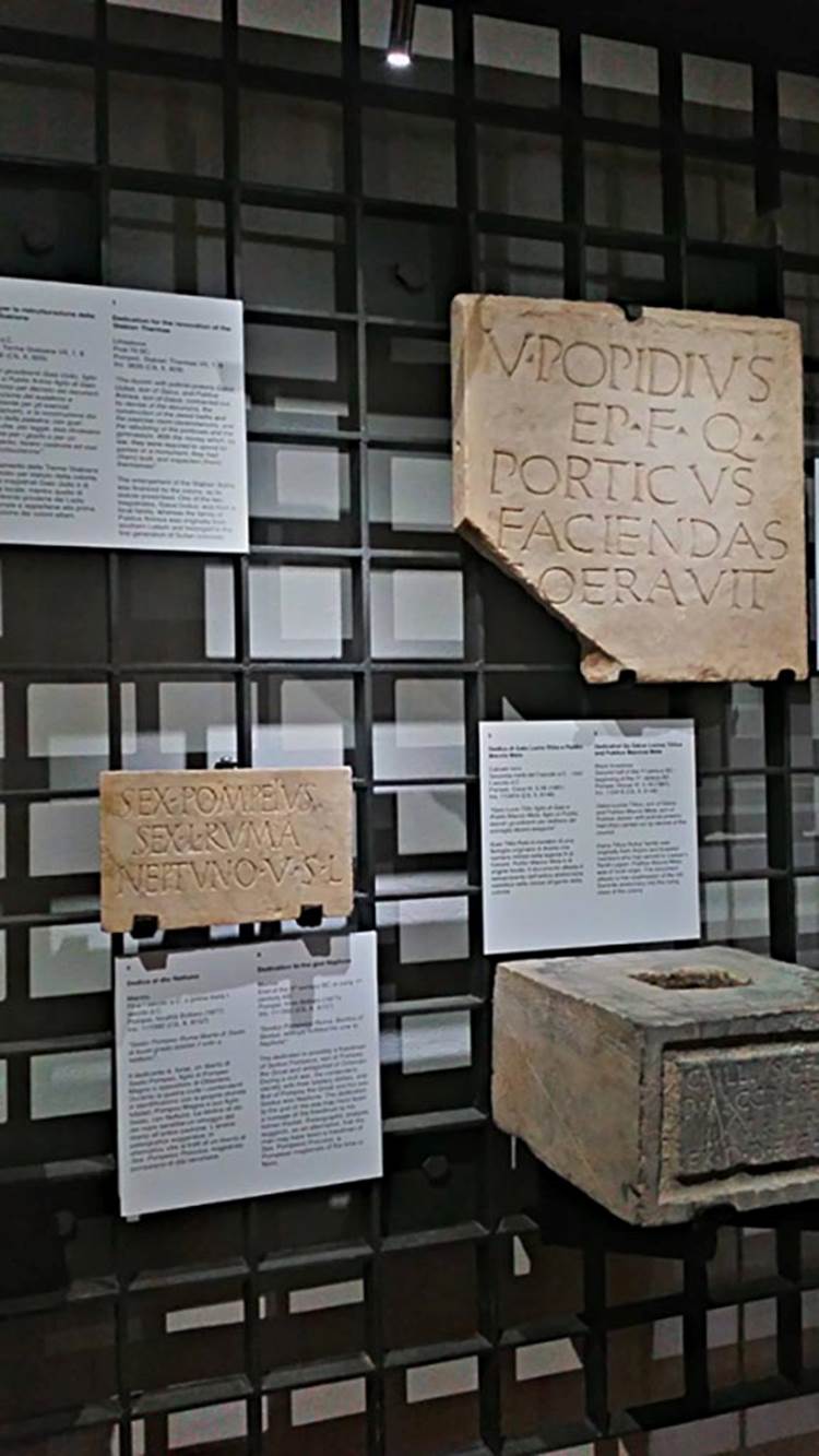 VIII.1.1 Pompeii. Top right, found in front of the Basilica, 1814,
“V. POPIDIUS, SON OF EPIDIUS, QUAESTOR, HAD THIS PORTICO BUILT”.
Now in Naples Archaeological Museum, inv. 3825 (CIL X, 794). Photo courtesy of Giuseppe Ciaramella, June 2017.
According to Naples Archaeological Museum information card –
“Marble dedication of a portico by the quaestor Vibius Popidius, from Early 1st century BC.
This is the earliest known Latin text from Pompeii. It refers to the tuff portico along the south side of the Forum.
The office of quaestor was not included in the statute of the colony founded by Sulla in 80 BC, but may have been in the statute introduced after the Social War (87 BC), and this possibly explains its occurrence here. The Popidii were one of the oldest local families and as such were excluded from the ruling class of the colony.”
Bottom left, from Temple of Neptune by the river mouth, loc Bottaro.
Bottom right, from VI.5.16.