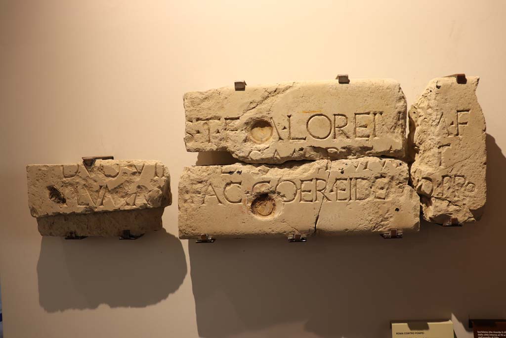 VIII.1.4 Pompeii. February 2021.
Limestone inscription recording the rebuilding of the town walls in about 70BCE after the damages caused by Sulla’s siege, found in VII.1.40.
Photo courtesy of Fabien Bièvre-Perrin (CC BY-NC-SA).
According to Epigraphic Database Roma this and reads
It was found in VII.1.40, House of M. Caesius Blandus (or of Mars and Venus), in pieces 'some of which served for the edge of a door, and others spread on the floor of the peristyle' (aa. 1862-1868).